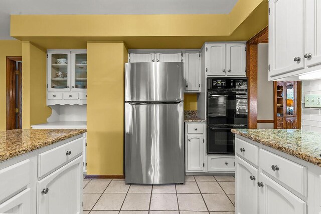 1212 Autumn Creek Cir, Westerville, OH 43081 - kitchen featuring freestanding refrigerator, white cabinets, light tile patterned floors, light stone counters, and glass insert cabinets