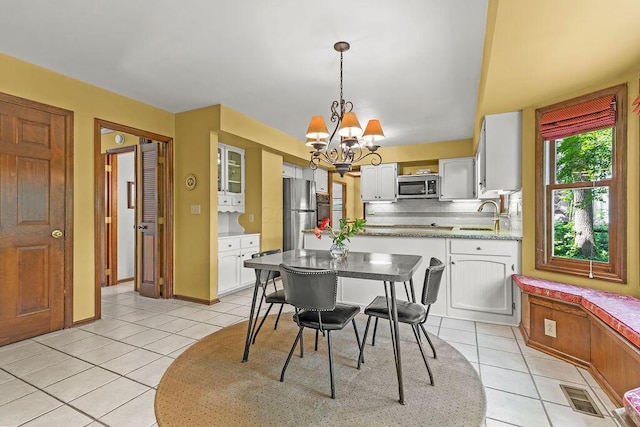 1212 Autumn Creek Cir, Westerville, OH 43081 - dining room with light tile patterned floors and a chandelier