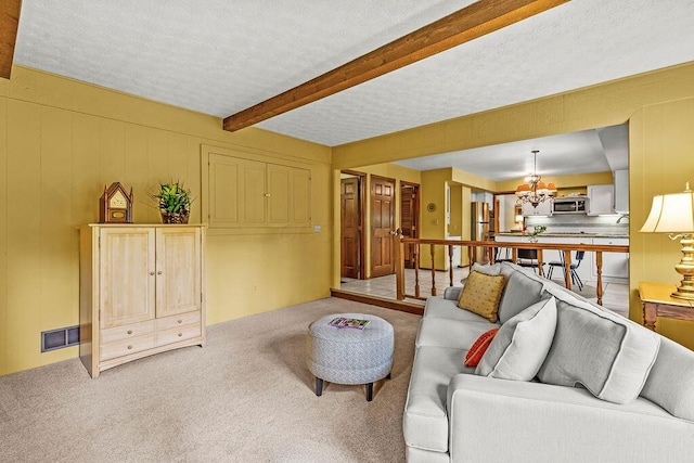 1212 Autumn Creek Cir, Westerville, OH 43081 - carpeted living area with a chandelier, beamed ceiling, and a textured ceiling