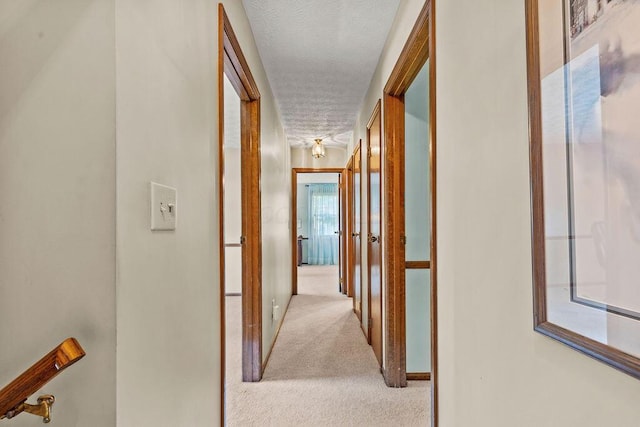 1212 Autumn Creek Cir, Westerville, OH 43081 - hallway featuring carpet floors, a textured ceiling, and french doors