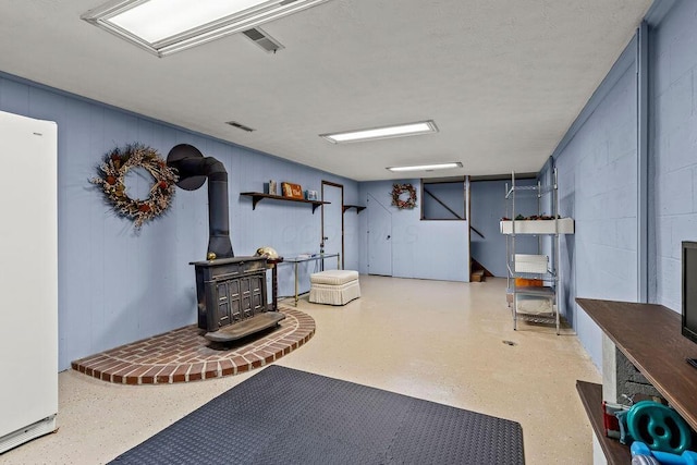 1212 Autumn Creek Cir, Westerville, OH 43081 - finished below grade area featuring a wood stove and freestanding refrigerator