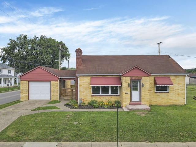 714 E 2nd St, Logan, OH 43138 - view of front of home with driveway, a front yard, an attached garage, and a chimney