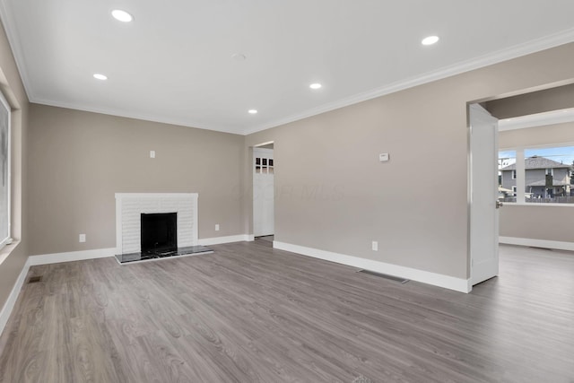 714 E 2nd St, Logan, OH 43138 - unfurnished living room featuring wood finished floors, crown molding, a fireplace, and recessed lighting