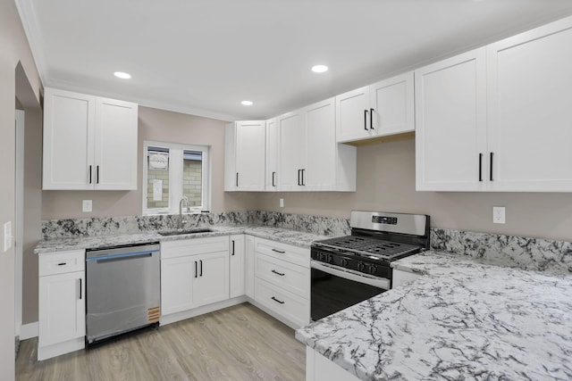 714 E 2nd St, Logan, OH 43138 - kitchen with appliances with stainless steel finishes, light wood finished floors, light stone counters, white cabinets, and recessed lighting
