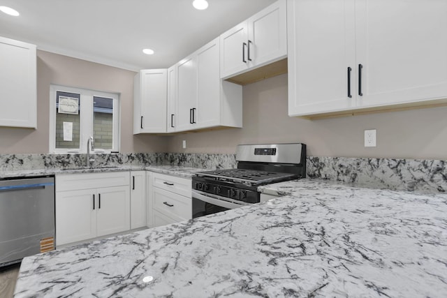 714 E 2nd St, Logan, OH 43138 - kitchen with stainless steel appliances, light stone counters, recessed lighting, and white cabinets