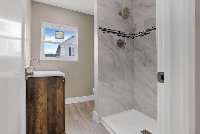714 E 2nd St, Logan, OH 43138 - full bath featuring a tile shower, vanity, and wood finished floors