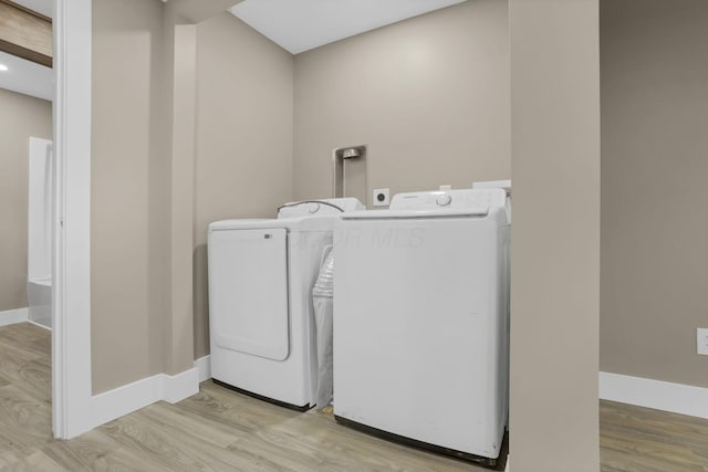 714 E 2nd St, Logan, OH 43138 - laundry room with independent washer and dryer and wood finished floors