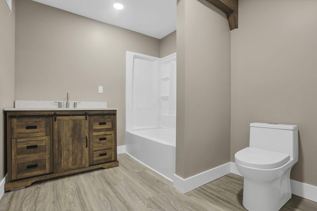 714 E 2nd St, Logan, OH 43138 - bathroom featuring wood finished floors, vanity, recessed lighting, and shower / bath combination