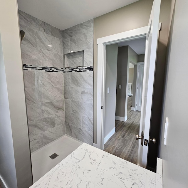 714 E 2nd St, Logan, OH 43138 - bathroom featuring tiled shower and wood finished floors