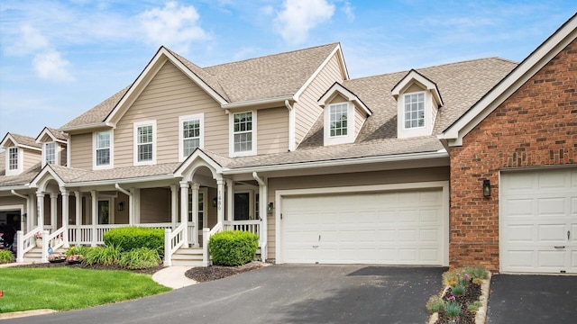 1486 Sedgefield Dr, New Albany, OH 43054 - view of front of house featuring asphalt driveway, a shingled roof, and a porch