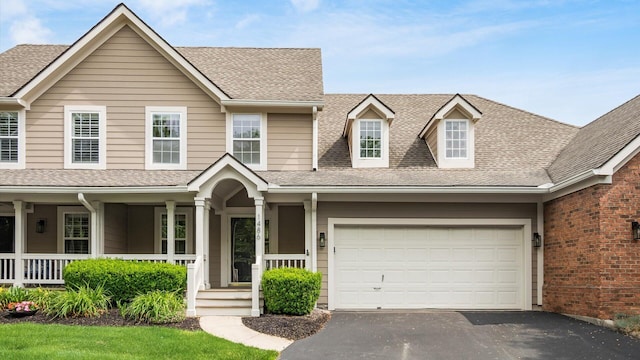 1486 Sedgefield Dr, New Albany, OH 43054 - view of front of home featuring driveway, a shingled roof, and a porch