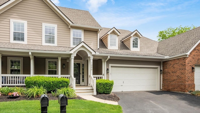 1486 Sedgefield Dr, New Albany, OH 43054 - view of front facade featuring driveway, an attached garage, covered porch, and a shingled roof