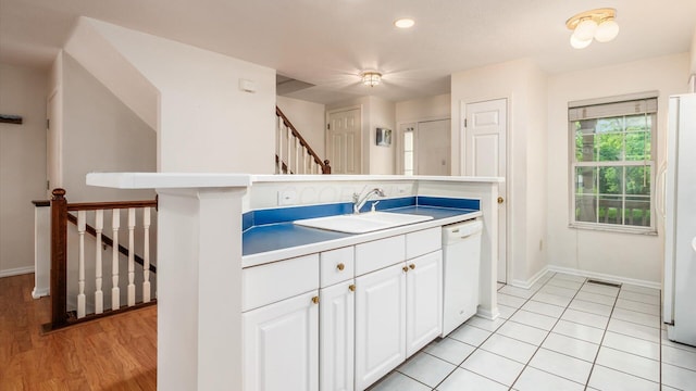 1486 Sedgefield Dr, New Albany, OH 43054 - kitchen with white dishwasher, white cabinetry, recessed lighting, and light countertops