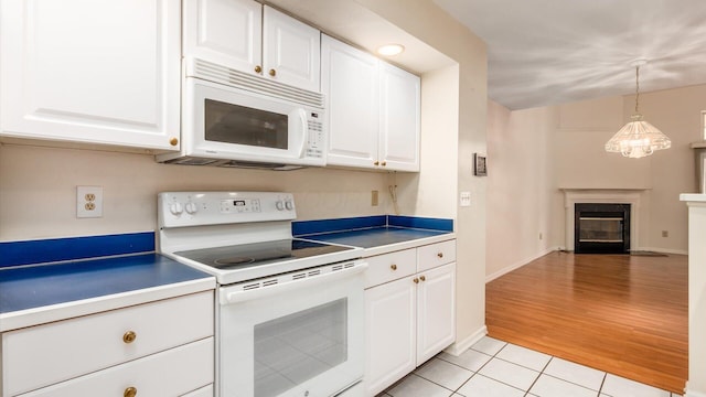 1486 Sedgefield Dr, New Albany, OH 43054 - kitchen with white appliances, light tile patterned floors, white cabinetry, and a fireplace