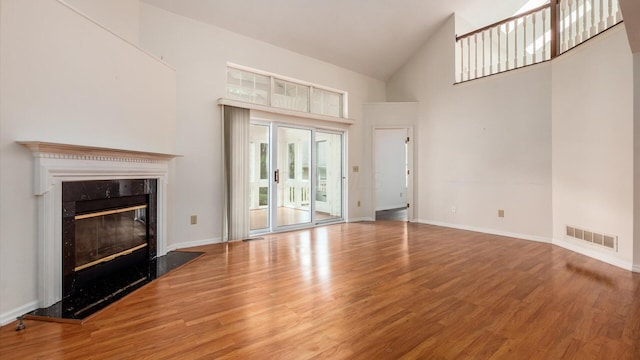 1486 Sedgefield Dr, New Albany, OH 43054 - unfurnished living room featuring high vaulted ceiling, wood finished floors, and a high end fireplace