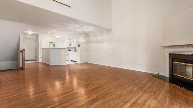 1486 Sedgefield Dr, New Albany, OH 43054 - unfurnished living room featuring wood finished floors and a premium fireplace