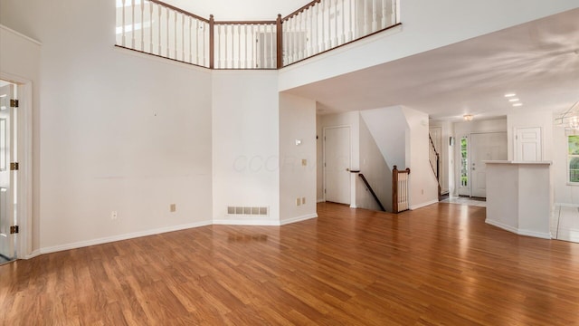 1486 Sedgefield Dr, New Albany, OH 43054 - unfurnished living room featuring wood finished floors and a towering ceiling
