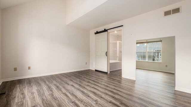 1486 Sedgefield Dr, New Albany, OH 43054 - empty room featuring a barn door and wood finished floors