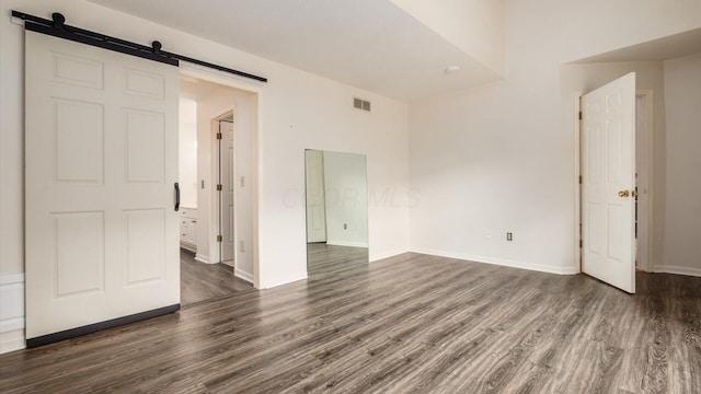 1486 Sedgefield Dr, New Albany, OH 43054 - empty room with a barn door and dark wood finished floors