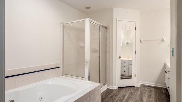 1486 Sedgefield Dr, New Albany, OH 43054 - bathroom with vanity, a shower stall, a tub with jets, and wood finished floors