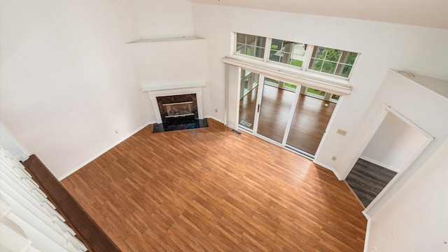 1486 Sedgefield Dr, New Albany, OH 43054 - unfurnished living room with wood finished floors, a premium fireplace, and a towering ceiling