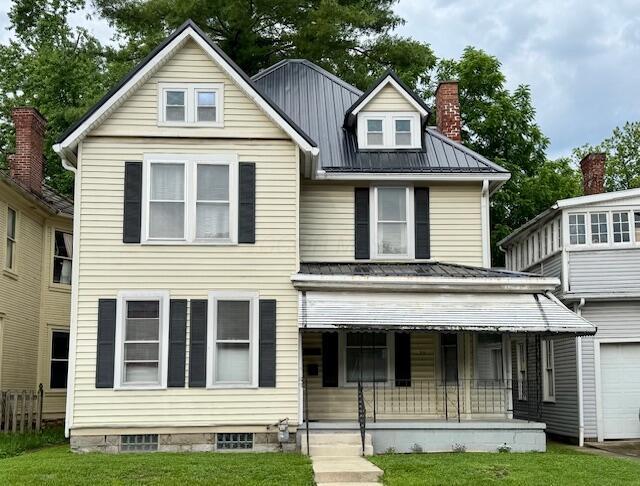 95 S Walnut St, Chillicothe, OH 45601 - view of front of home featuring covered porch, metal roof, a garage, and a front yard