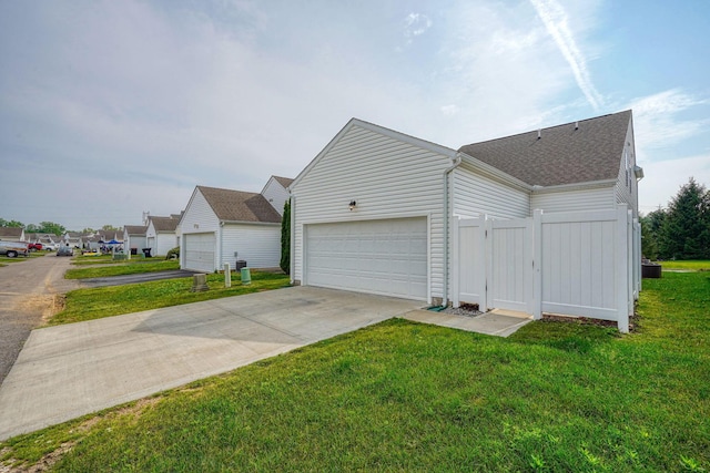 1957 Cumberland St, Newark, OH 43055 - view of side of home featuring roof with shingles, an attached garage, and driveway