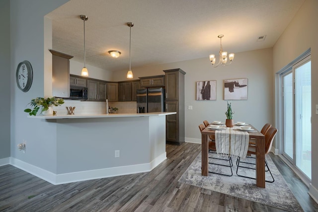 1957 Cumberland St, Newark, OH 43055 - kitchen with stainless steel appliances, plenty of natural light, dark wood finished floors, backsplash, and a textured ceiling