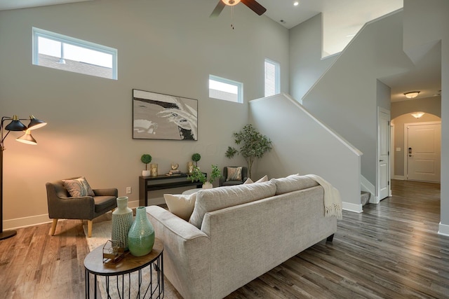 1957 Cumberland St, Newark, OH 43055 - living area with a high ceiling, stairway, arched walkways, ceiling fan, and dark wood-style flooring