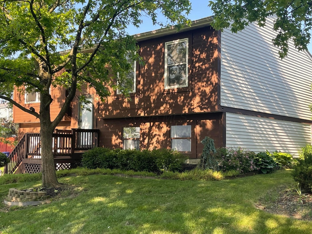 7603 Charlesway Dr Unit 87, Columbus, OH 43085 - view of home's exterior with a yard and a deck