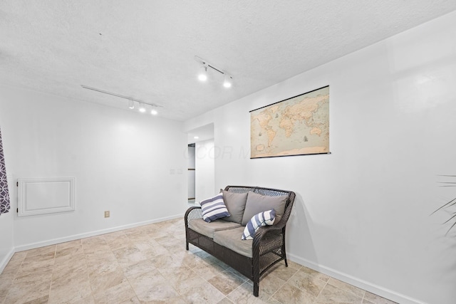 7603 Charlesway Dr Unit 87, Columbus, OH 43085 - living area featuring rail lighting and a textured ceiling