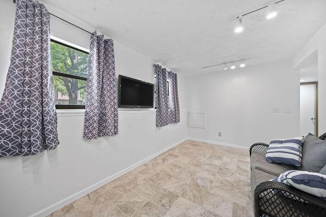 7603 Charlesway Dr Unit 87, Columbus, OH 43085 - living room featuring rail lighting and a textured ceiling