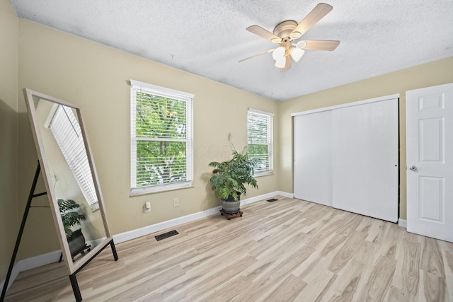 7603 Charlesway Dr Unit 87, Columbus, OH 43085 - unfurnished bedroom featuring wood finished floors, a textured ceiling, a closet, and ceiling fan