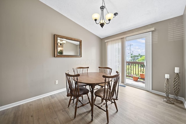 7603 Charlesway Dr Unit 87, Columbus, OH 43085 - dining area with a chandelier, lofted ceiling, and light wood-type flooring