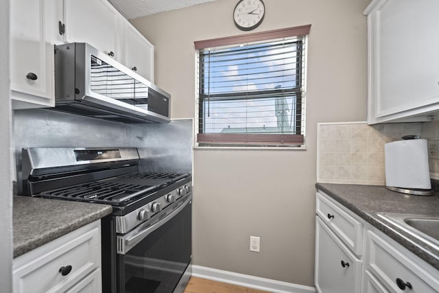 7603 Charlesway Dr Unit 87, Columbus, OH 43085 - kitchen featuring appliances with stainless steel finishes, decorative backsplash, white cabinets, and dark countertops