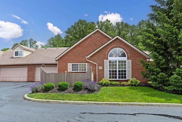 6858 Winrock Dr, New Albany, OH 43054 - view of front of home with brick siding, a garage, and asphalt driveway