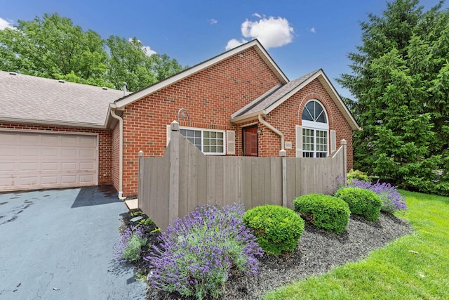 6858 Winrock Dr, New Albany, OH 43054 - view of property exterior featuring brick siding, driveway, a garage, and roof with shingles