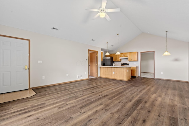 6858 Winrock Dr, New Albany, OH 43054 - unfurnished living room with dark wood-style flooring, high vaulted ceiling, and ceiling fan