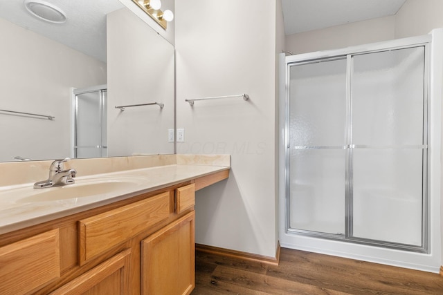 6858 Winrock Dr, New Albany, OH 43054 - bathroom with vanity, a stall shower, and wood finished floors