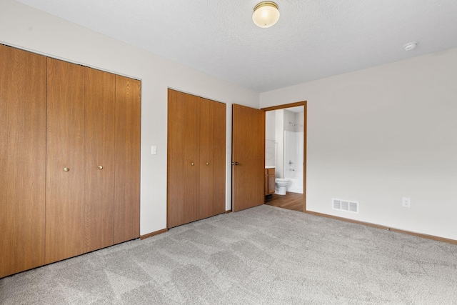6858 Winrock Dr, New Albany, OH 43054 - unfurnished bedroom with multiple closets, carpet, and ensuite bath