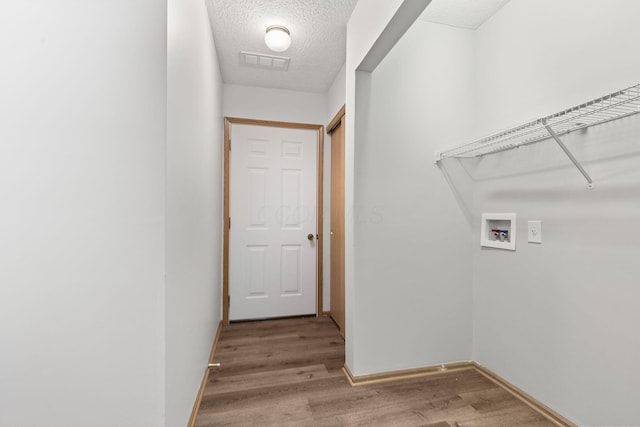6858 Winrock Dr, New Albany, OH 43054 - laundry room featuring washer hookup, wood finished floors, and a textured ceiling
