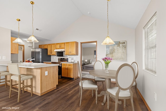 6858 Winrock Dr, New Albany, OH 43054 - kitchen featuring stainless steel appliances, dark wood-style floors, light countertops, high vaulted ceiling, and a peninsula