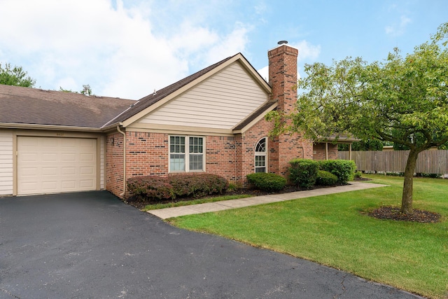 9427 Clermont Cir, Powell, OH 43065 - view of front of property with brick siding, an attached garage, a chimney, and driveway