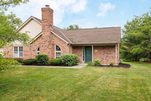 9427 Clermont Cir, Powell, OH 43065 - view of front of property featuring brick siding, a front lawn, a chimney, and roof with shingles