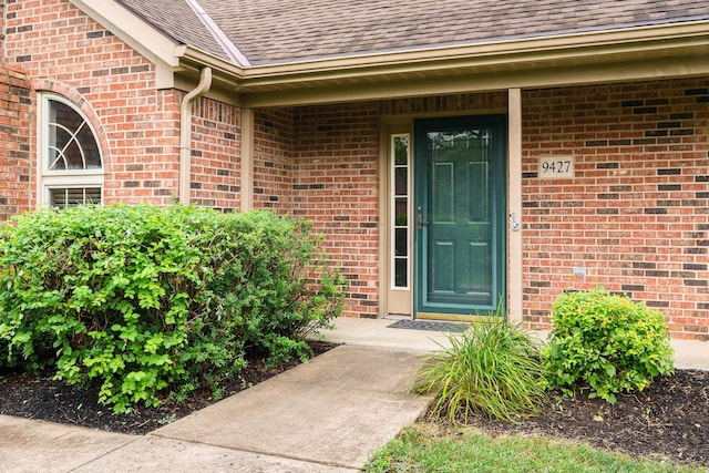 9427 Clermont Cir, Powell, OH 43065 - view of exterior entry with roof with shingles and brick siding
