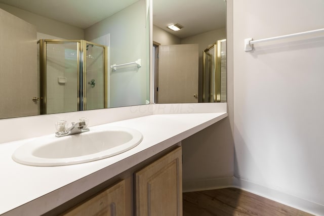 9427 Clermont Cir, Powell, OH 43065 - bathroom with a stall shower, vanity, and wood finished floors