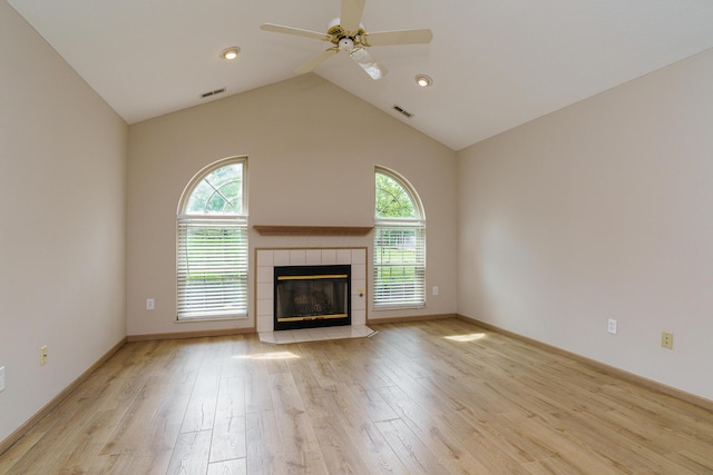 9427 Clermont Cir, Powell, OH 43065 - unfurnished living room featuring ceiling fan, light wood-style floors, a tiled fireplace, lofted ceiling, and recessed lighting