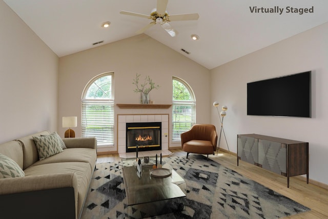 9427 Clermont Cir, Powell, OH 43065 - living room with wood finished floors, a ceiling fan, plenty of natural light, a fireplace, and lofted ceiling