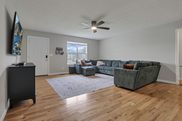 5010 Nelson Dr, South Bloomfield, OH 43103 - living room featuring ceiling fan, light wood-style floors, a textured ceiling, and baseboards