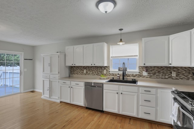 5010 Nelson Dr, South Bloomfield, OH 43103 - kitchen featuring stainless steel appliances, a sink, tasteful backsplash, light wood-type flooring, and white cabinets